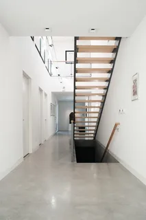 Ultra-shiny polished concrete surface reflecting interior light fixtures to illustrate key polished concrete steps