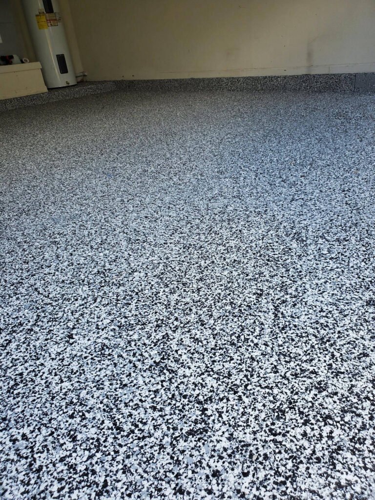 A close-up of a durable epoxy-coated concrete floor surface, illustrating a seamless flooring alternative in the paver patio vs concrete comparison